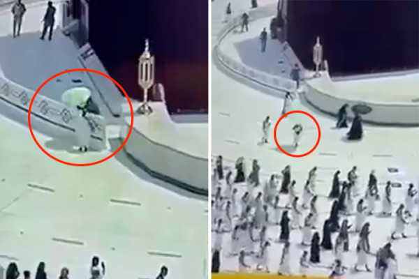 Security man gives his umbrella to a pilgrim suffering from heat at the Great Mosque of Makkah