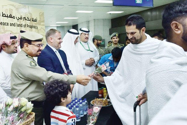 Pilgrims greeted with flowers, sweets — and health advice